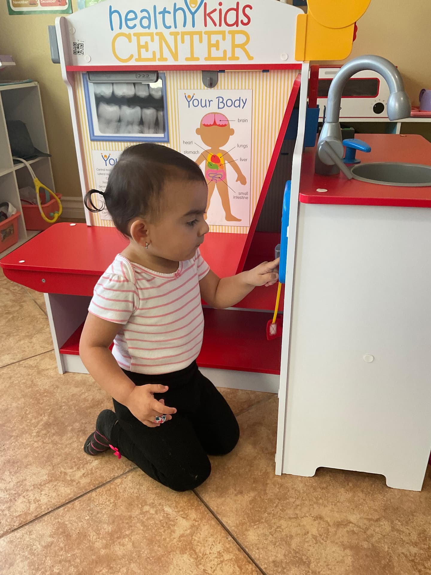 Toddler exploring a healthy kids doctor play center