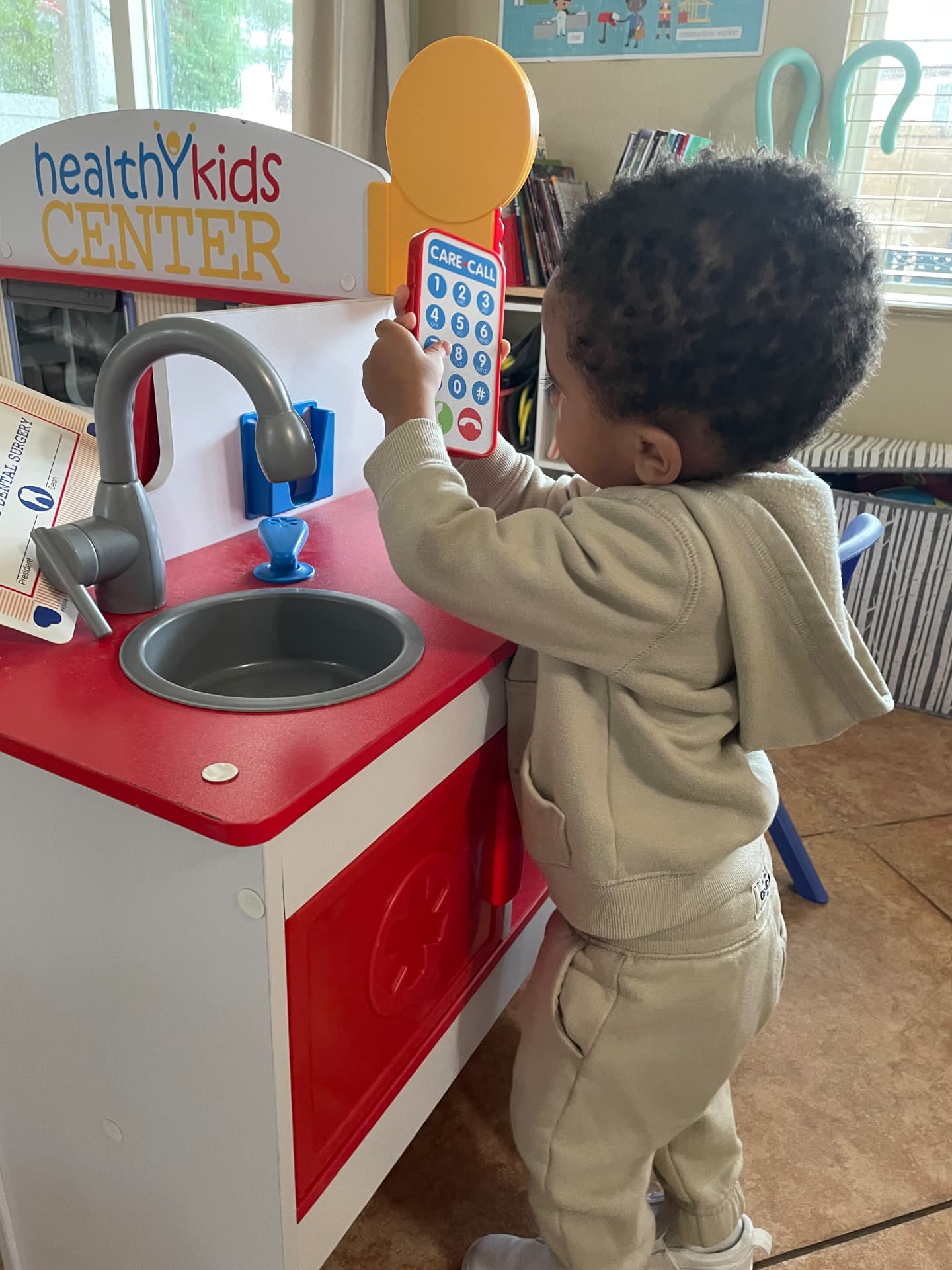 Child answering the phone at a Healthy Kids doctor play center