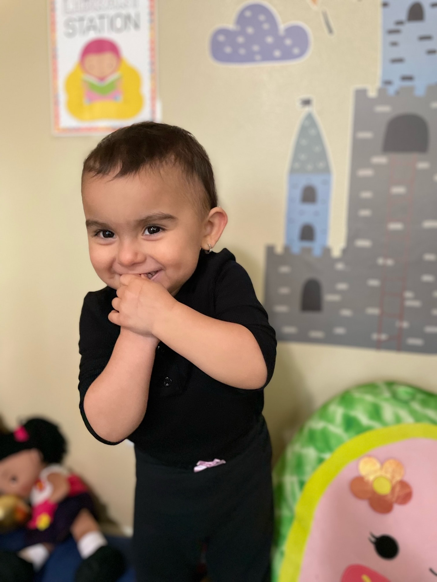 Happy toddler standing by the castle-themed reading corner