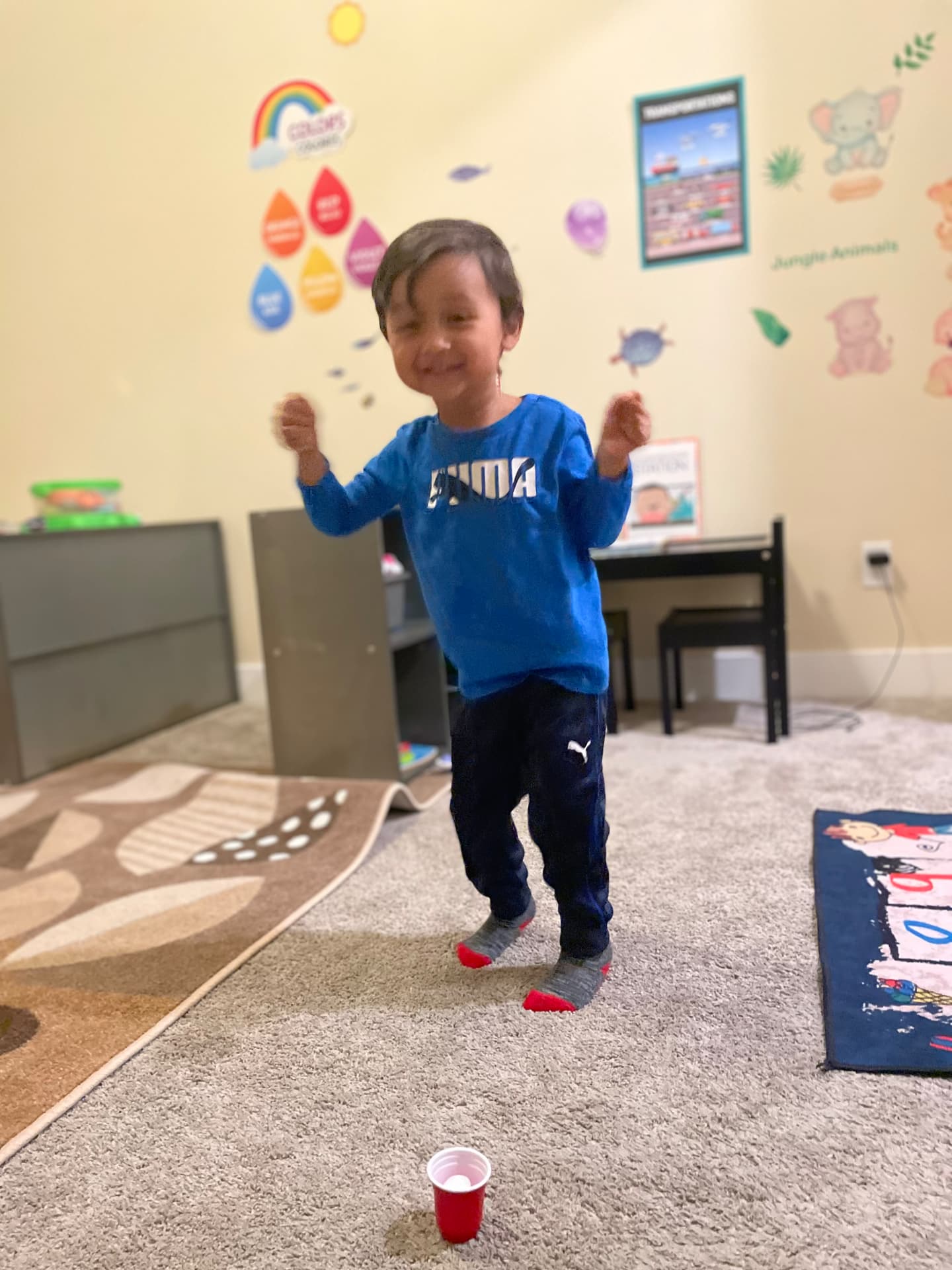 Smiling preschooler dancing in the learning room