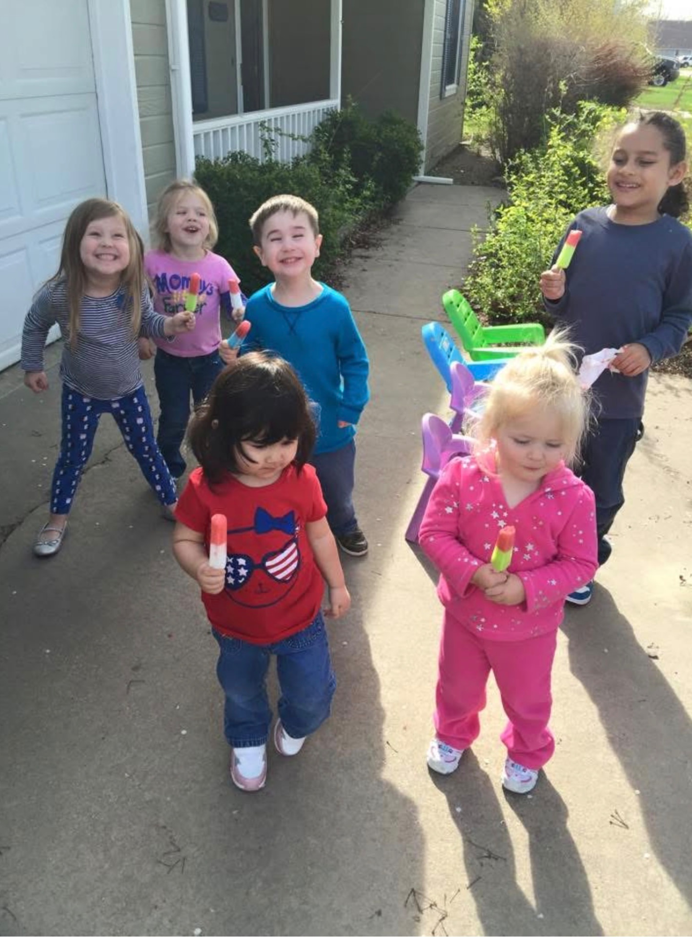 Group of children holding popsicles outside