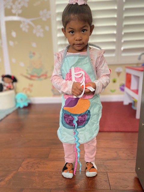 Child wearing an apron ready for a cooking activity